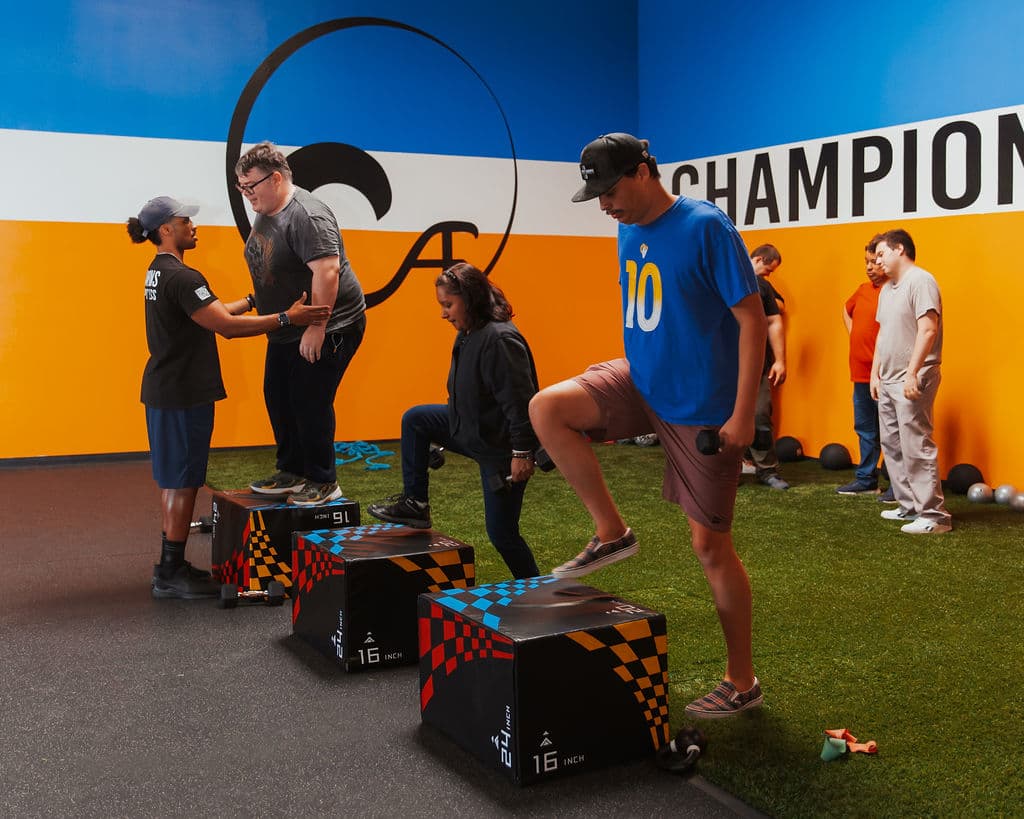 Group adaptive fitness class with box jumps
